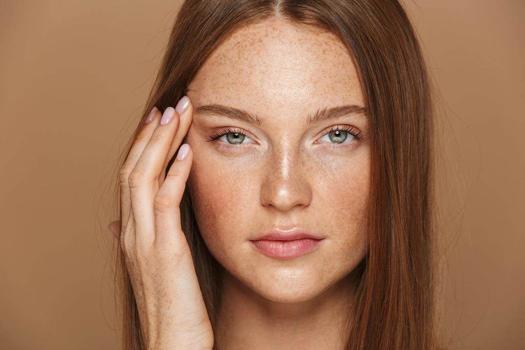 Women with smooth skin, silk ginger hair and subtle makeup on