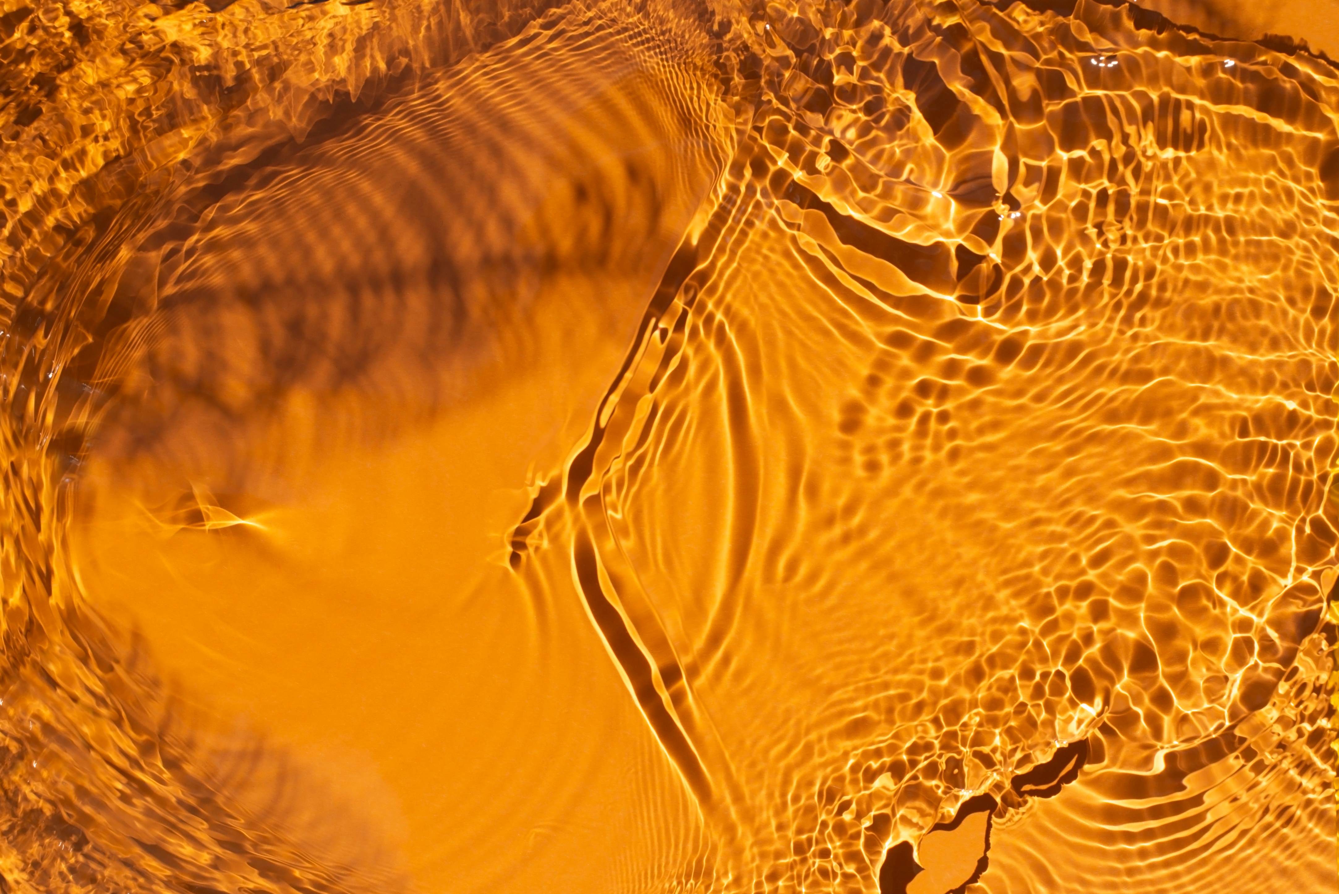 Water on bright orange background