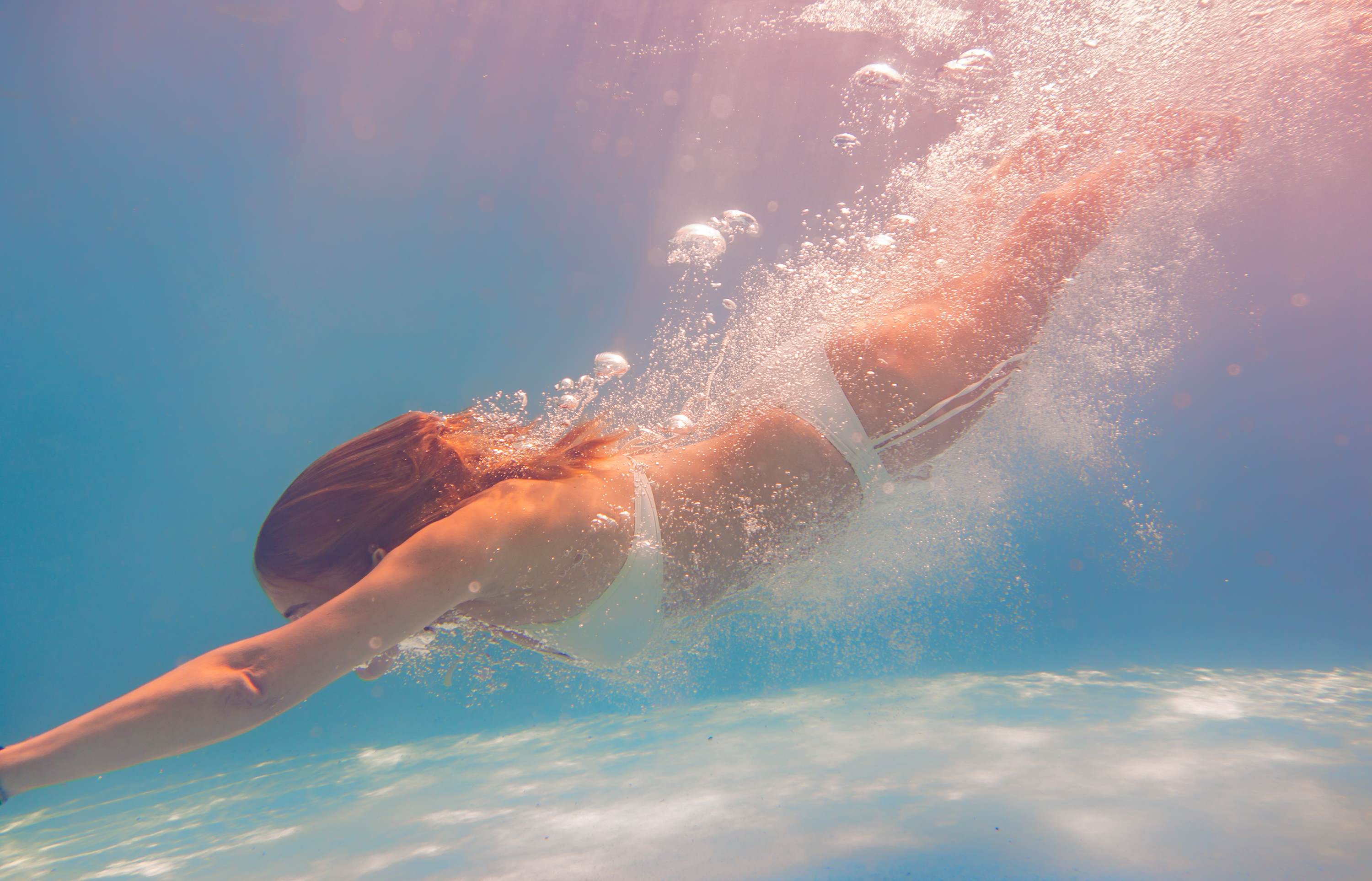 female diving into the sea